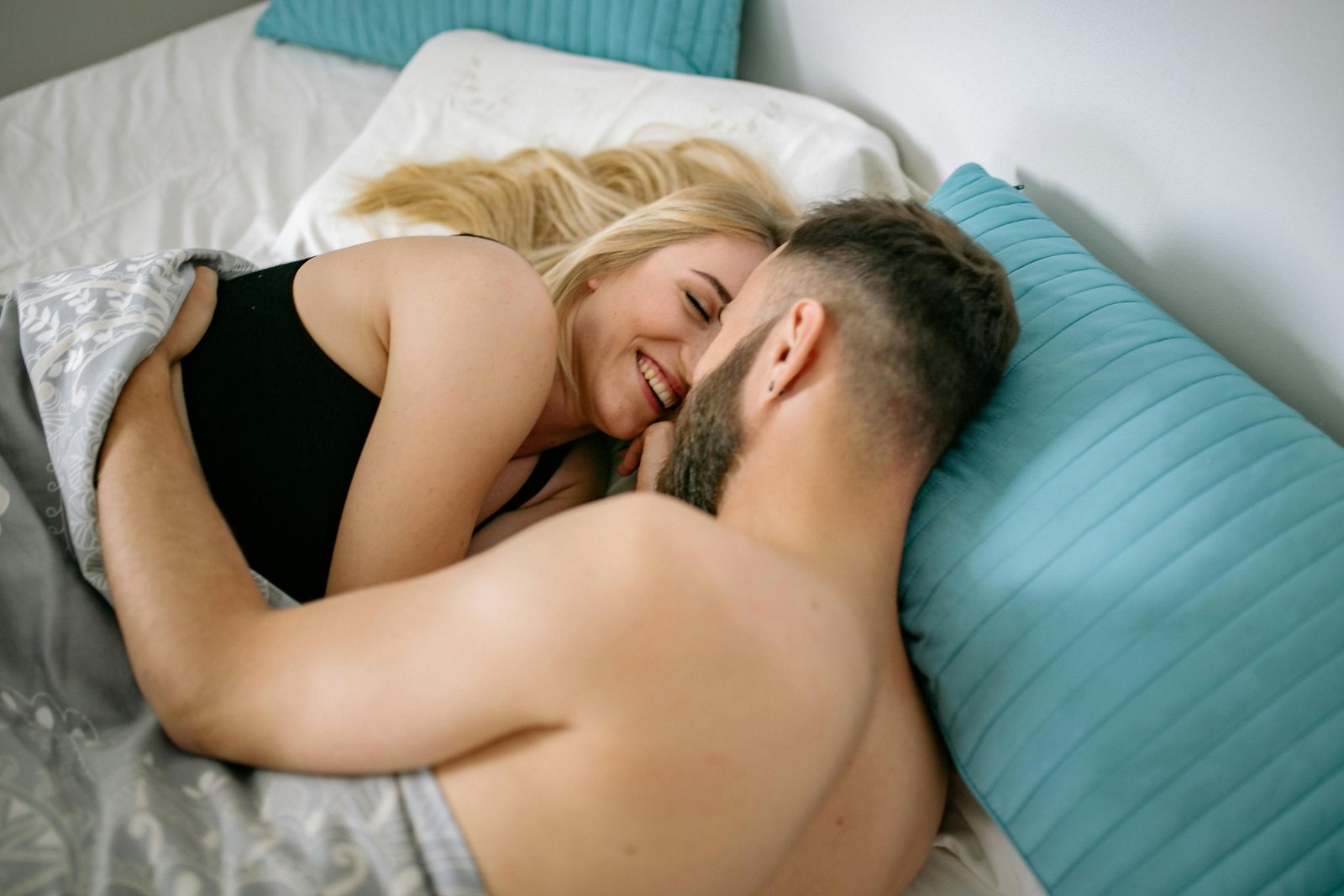 Homem e mulher abraçados na cama como um programa de bem-estar